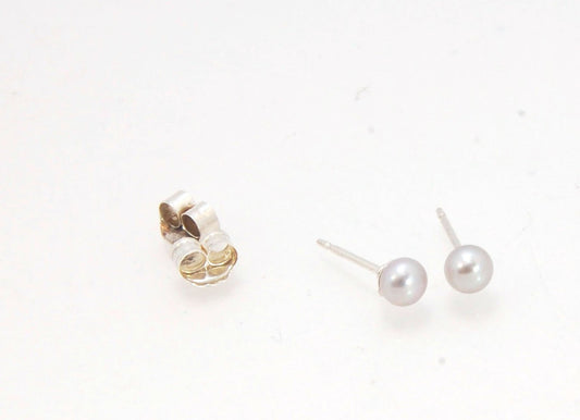 Grey Freshwater pearls studs in Sterling silver - 4mm These tiny luminous grey freshwater pearls are 4mm and set in sterling silver pearl cups and posts with sterling silver ear nuts. Made to Order Sterling and Freshwater pearls