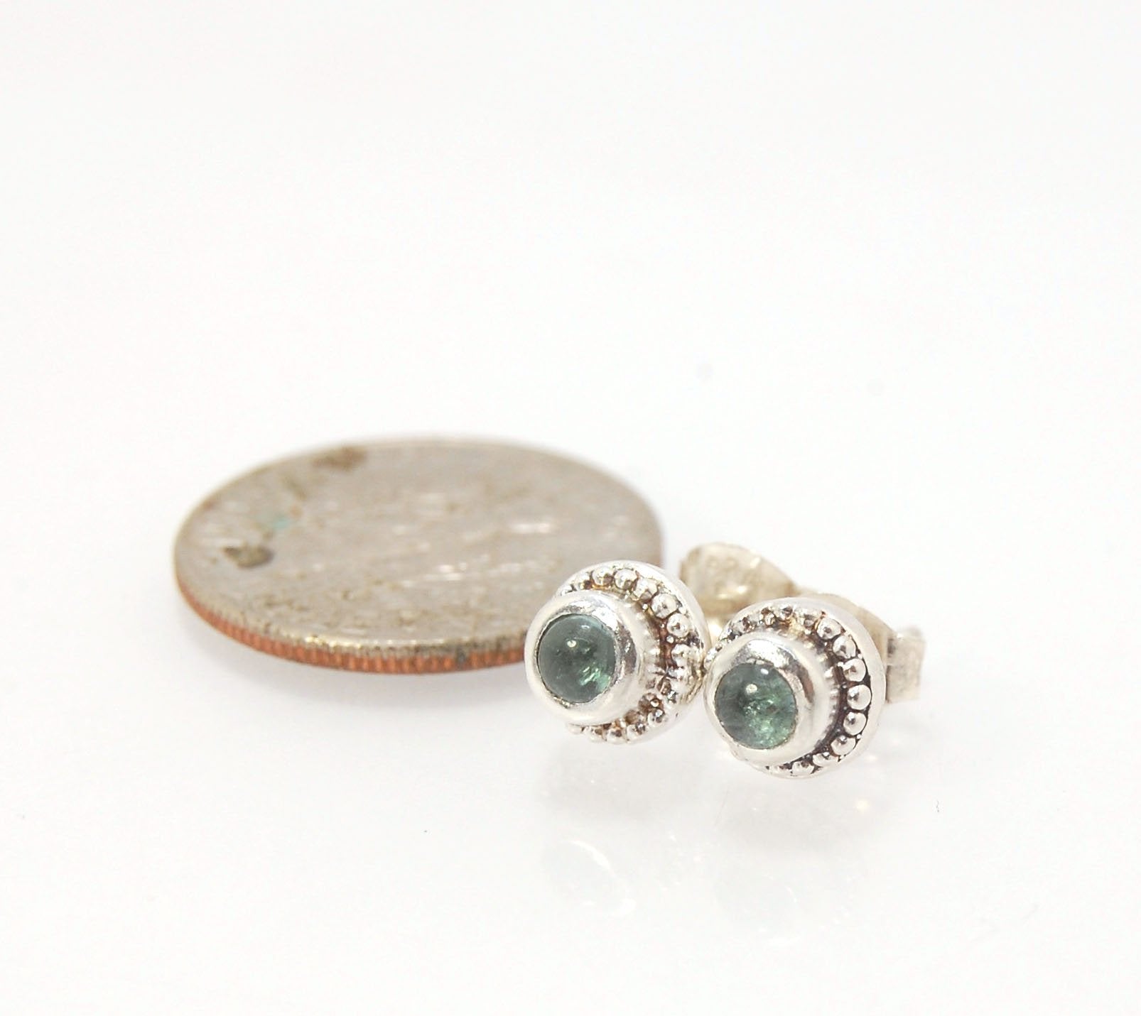 BlueGreen Tourmaline Tiny Post Earrings in Sterling Silver These are tiny bezel settings I created using the ancient process of granulation. Then I made a mold of it and injected the mold with wax and used that wax to create a Sterling Silver version of t