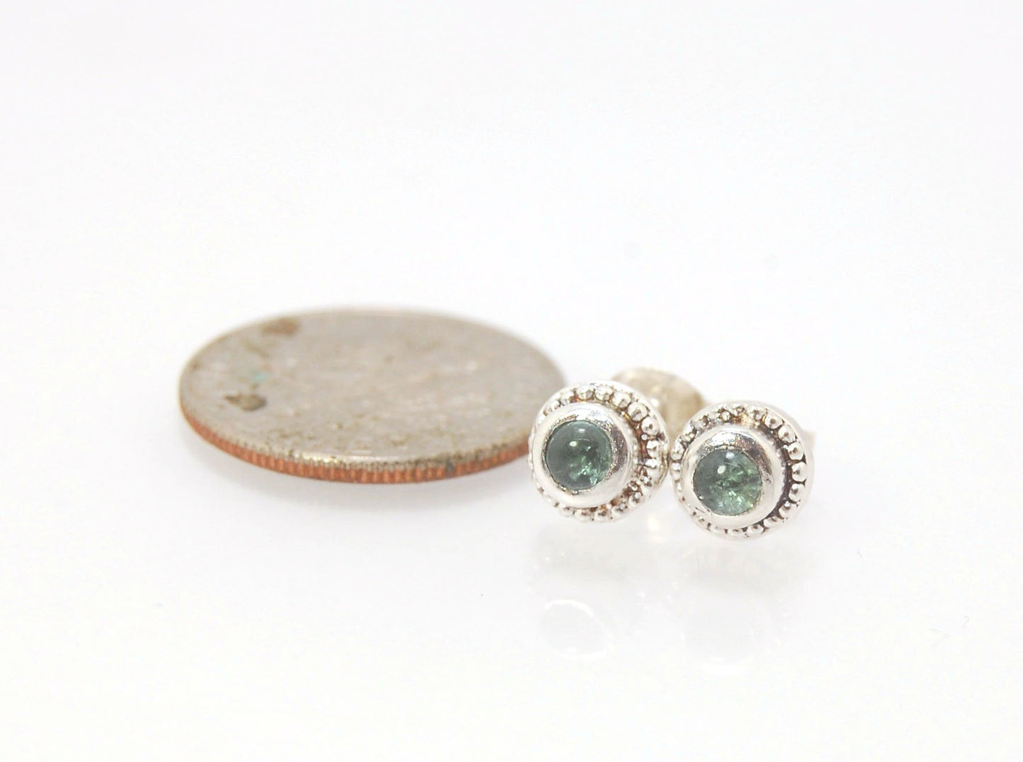 BlueGreen Tourmaline Tiny Post Earrings in Sterling Silver These are tiny bezel settings I created using the ancient process of granulation. Then I made a mold of it and injected the mold with wax and used that wax to create a Sterling Silver version of t