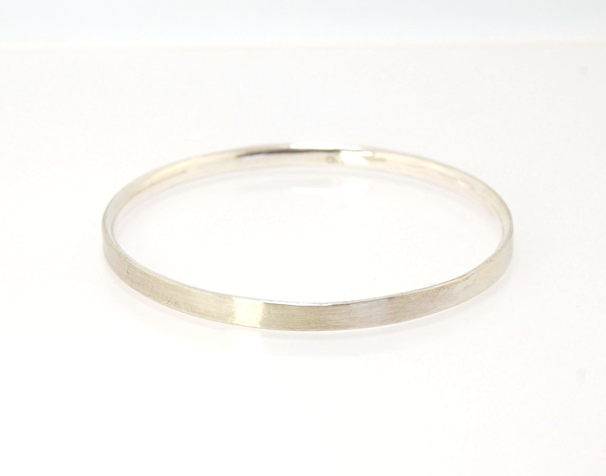 5mm Inverted Half Round Sterling Silver Bangles Who doesn’t love a good bangle stack! These comfortable inverted half round bangles are available in 2 finishes. Shiny or Matte.Handmade by me in my studio, I pour a large ingot of sterling silver and roll i