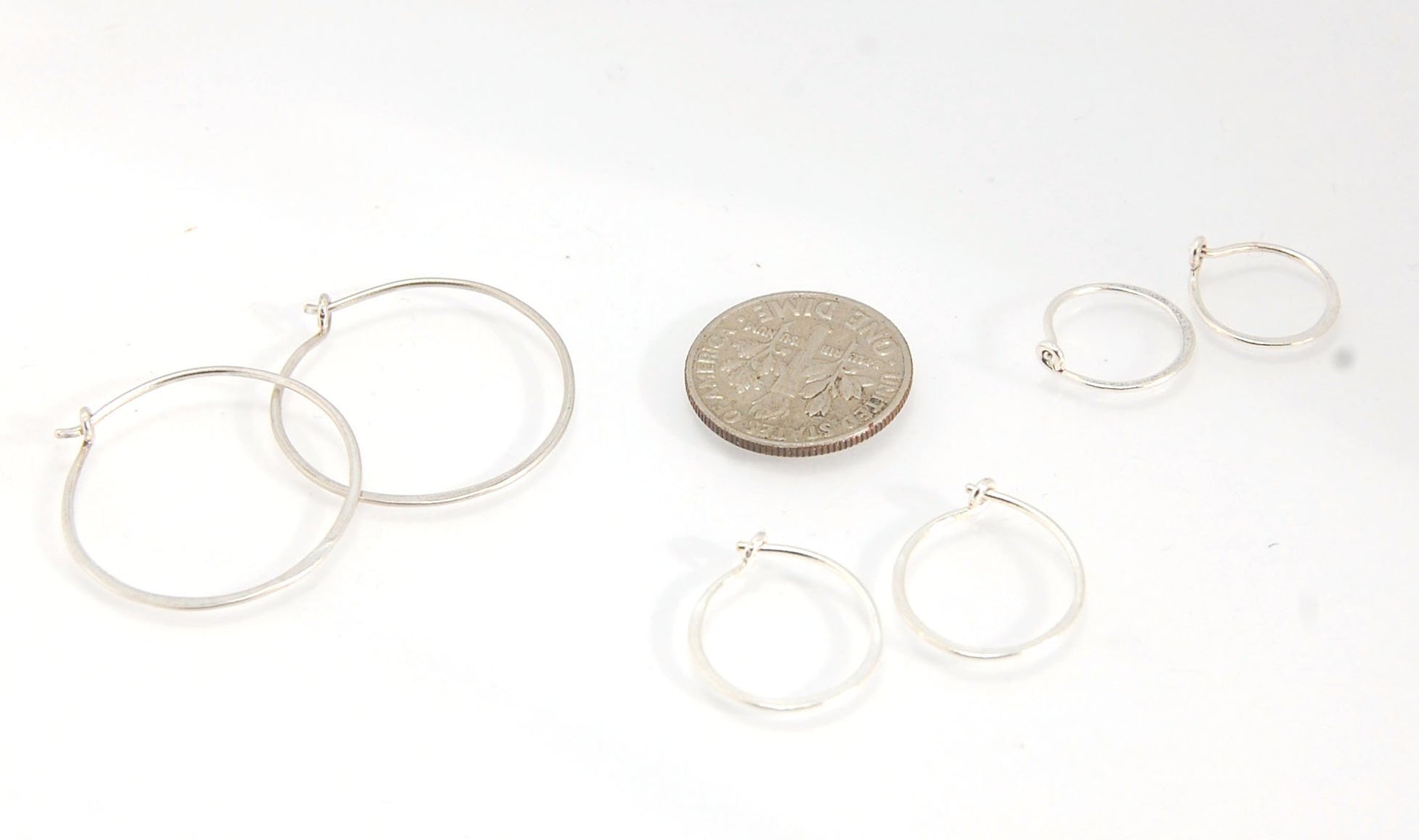 Hammered Hoops - Sterling - Small, Medium and Large Looking for an affordable handmade gift? Or some super lightweight Sterling Silver Hoops you can live in? These classic wire hammered hoops you can sleep and live in are forged from 20 gage Sterling wire