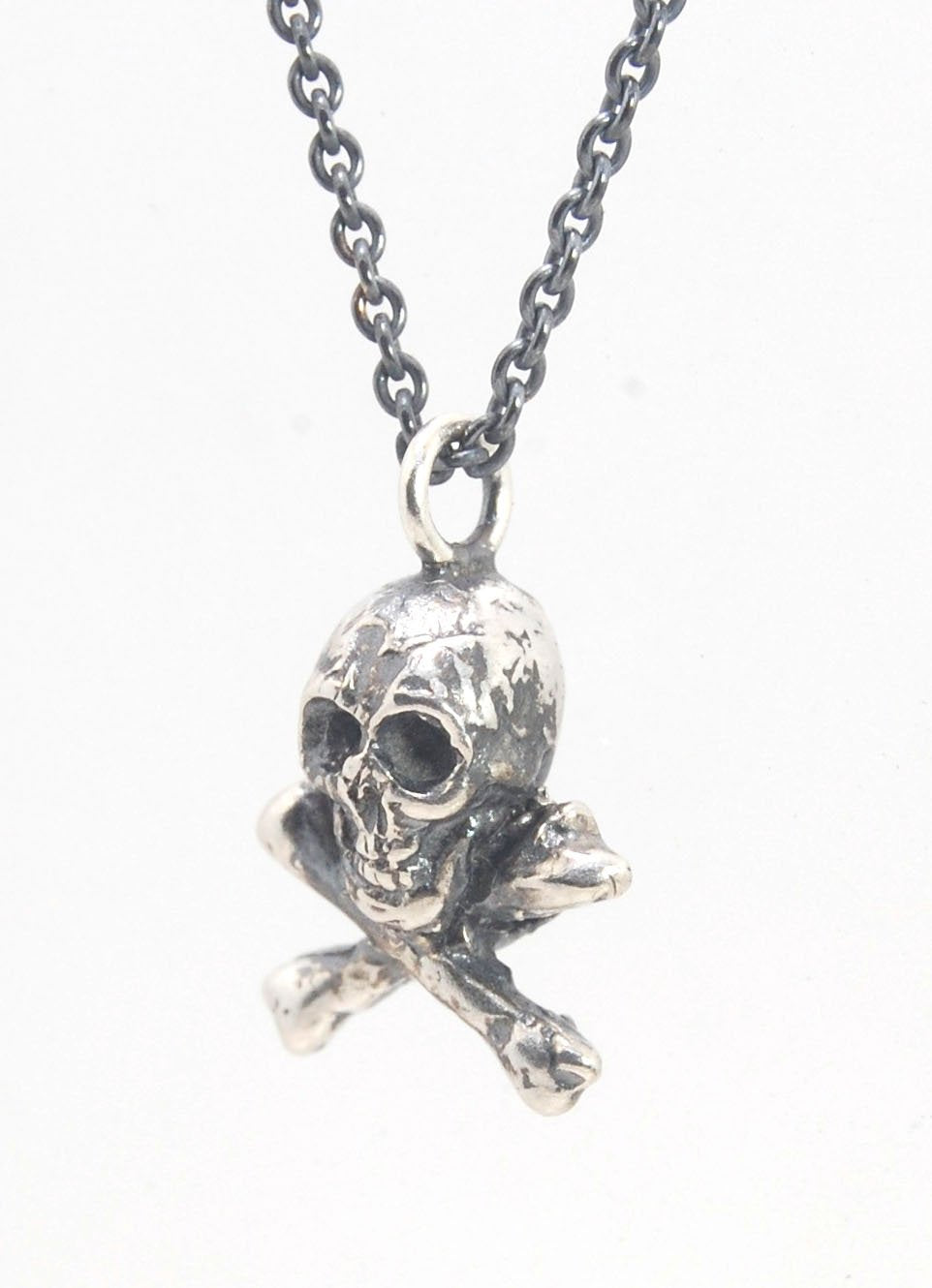 Jolly Roger Pendant This solid sterling silver Jolly Roger Pendant is wax carved by hand and cast using the ancient process of Lost Wax casting. I then made a mold, which I can inject with wax and make wax copies of the Jolly Roger Pendant and cast a lot