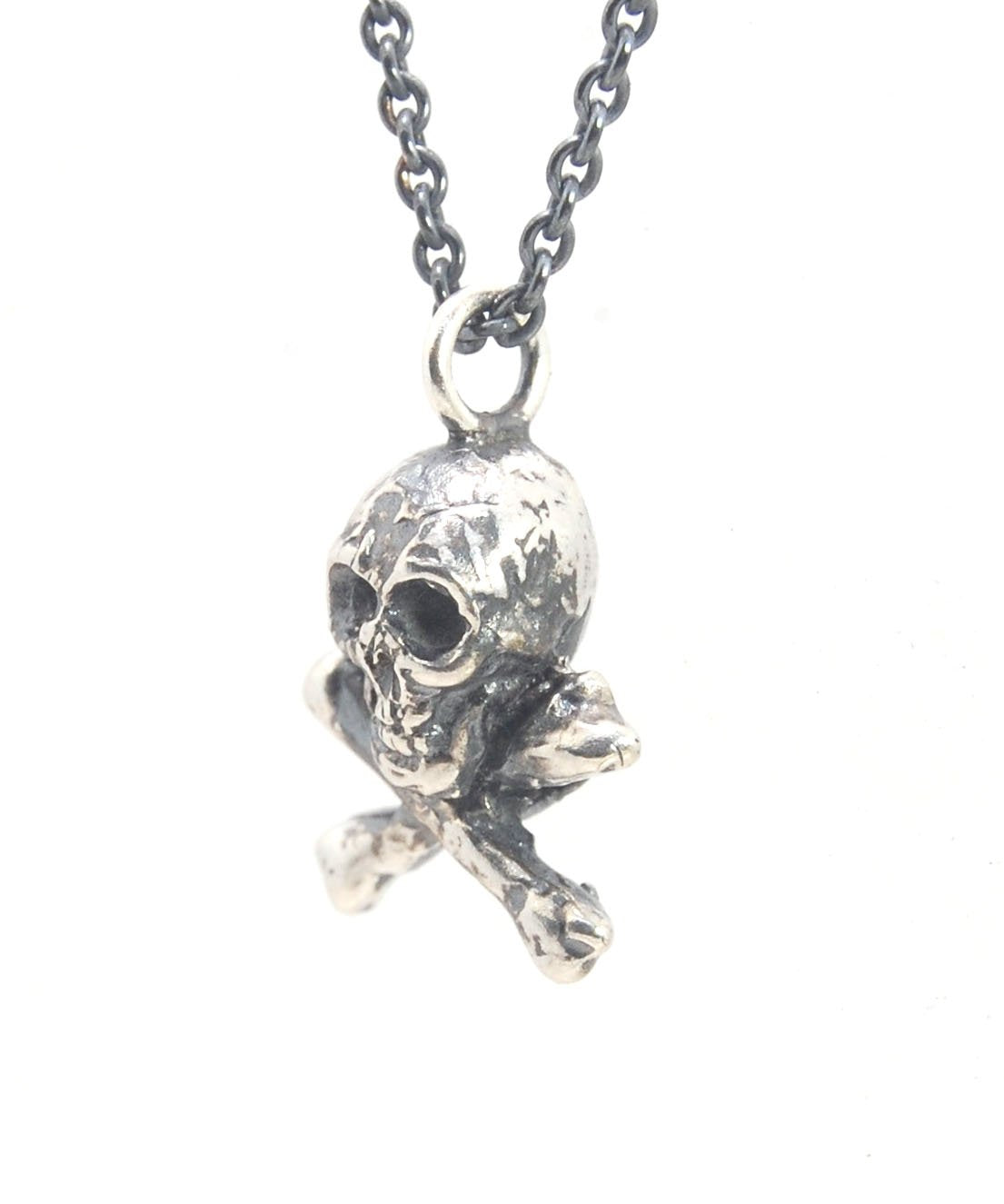 Jolly Roger Pendant This solid sterling silver Jolly Roger Pendant is wax carved by hand and cast using the ancient process of Lost Wax casting. I then made a mold, which I can inject with wax and make wax copies of the Jolly Roger Pendant and cast a lot