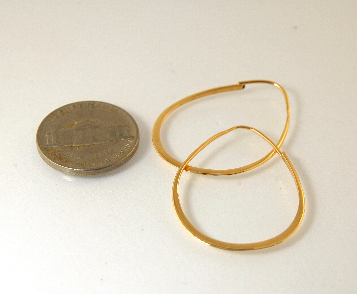 Long Hammered 14k gold Hoops These very lightweight hoops are shaped and hammered 14k gold. 35mm x 25mm