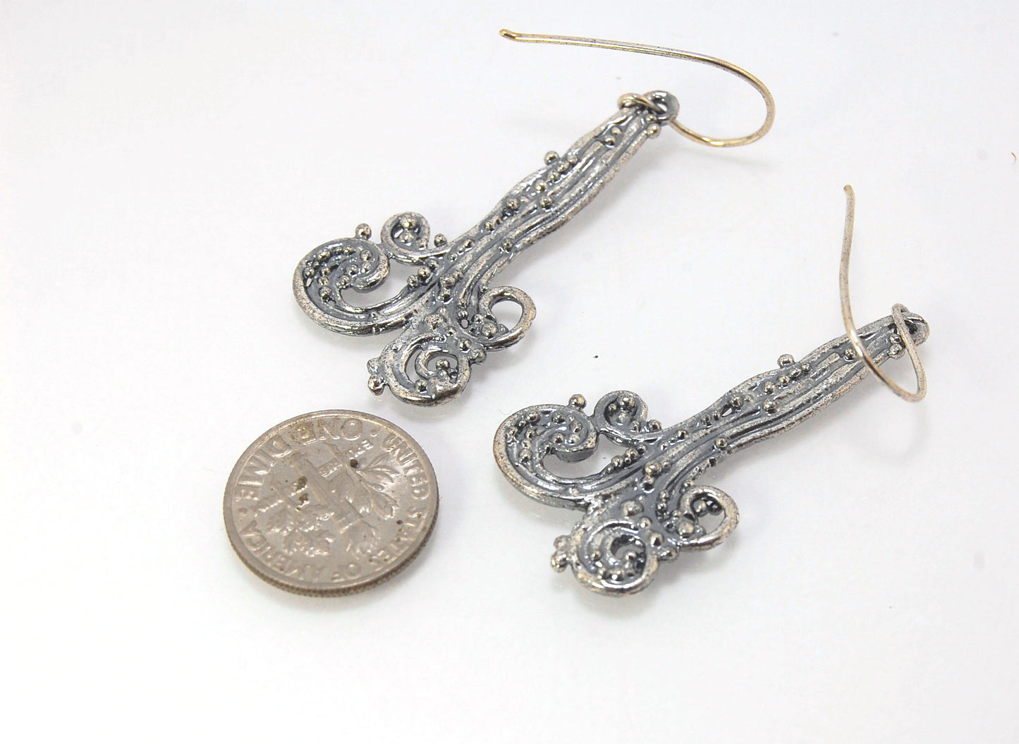 Waterfall Earrings These long Wave Dangles are part of my new work. These are cast versions of my original granulation work, which is then molded for repeat waxes and then cast using the Lost Wax process.These waterfall dangles have a dark patina and are