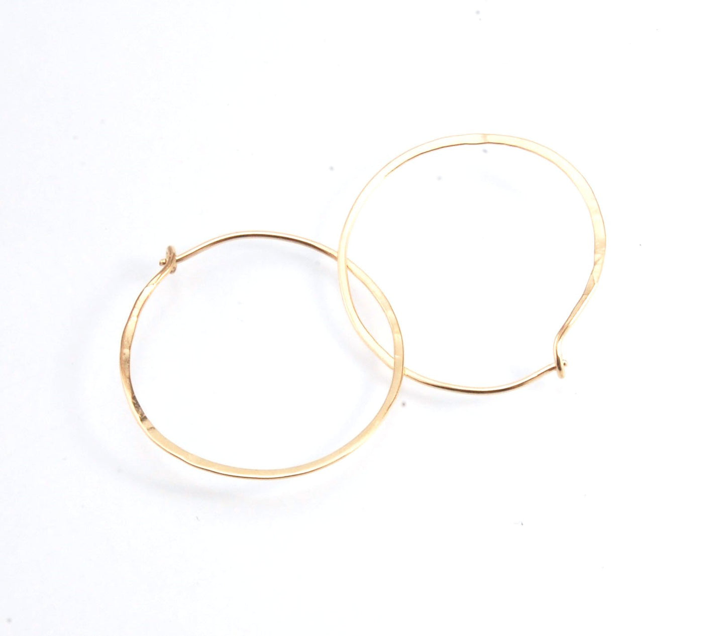 Hammered 14k Hoops - Small, Medium and Large These are exactly the same as my hammered sterling hoops, but they are made of solid 14k gold! They are super lightweight, classic wire hammered hoops you can sleep and live in. These delicate hoops are forged