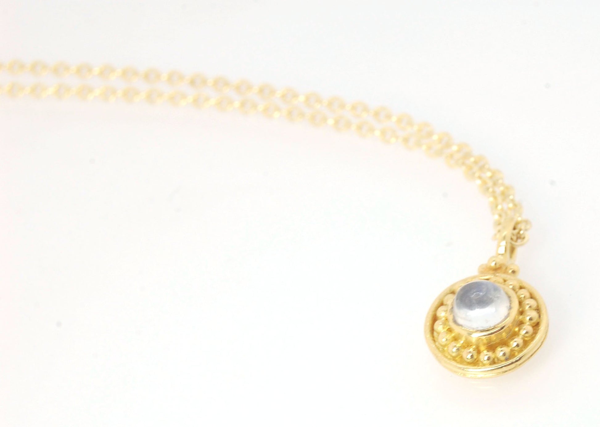 Tiny Round Rainbow Moonstone 18k gold Granulated Pendant This beautiful tiny round rainbow moonstone has so much luminance! A bezel-set small round rainbow moonstone is surrounded by larger 18k gold granules and can be ordered on the your chain of choice.