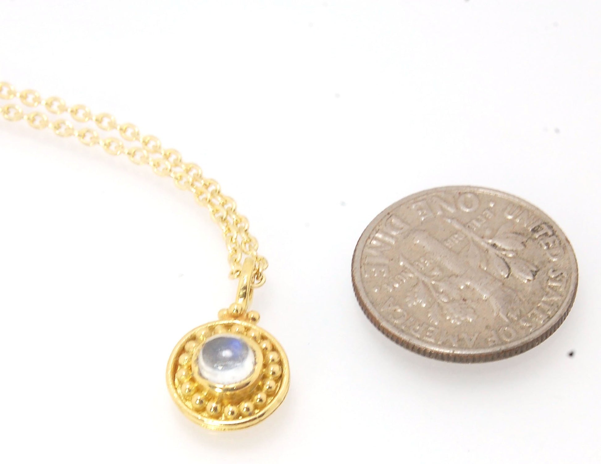 Tiny Round Rainbow Moonstone 18k gold Granulated Pendant This beautiful tiny round rainbow moonstone has so much luminance! A bezel-set small round rainbow moonstone is surrounded by larger 18k gold granules and can be ordered on the your chain of choice.