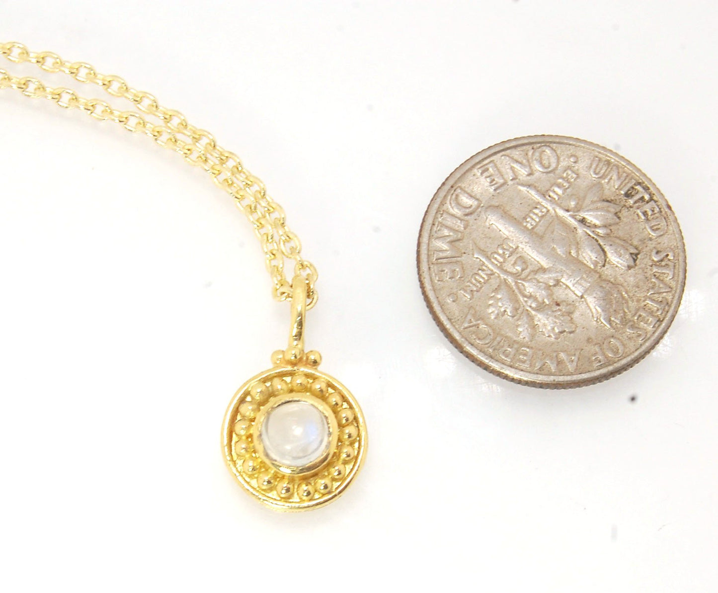 Tiny Round Rainbow Moonstone 18k gold Granulated Pendant This beautiful tiny round rainbow moonstone has so much luminance! A bezel-set small round rainbow moonstone is surrounded by larger 18k gold granules and can be ordered on the your chain of choice.