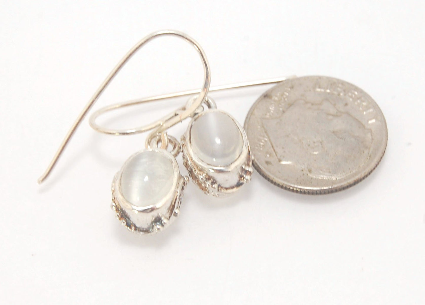 Oval Swirled Earrings with French Hooks in Sterling with your choice of Moonstone, Blue Chacedony, Amethyst, Rose Quartz, or Garnet These sweet swirled oval dangle earrings can be set with the stone of your choice: Moonstone, Blue Chacedony, Amethyst, Ros