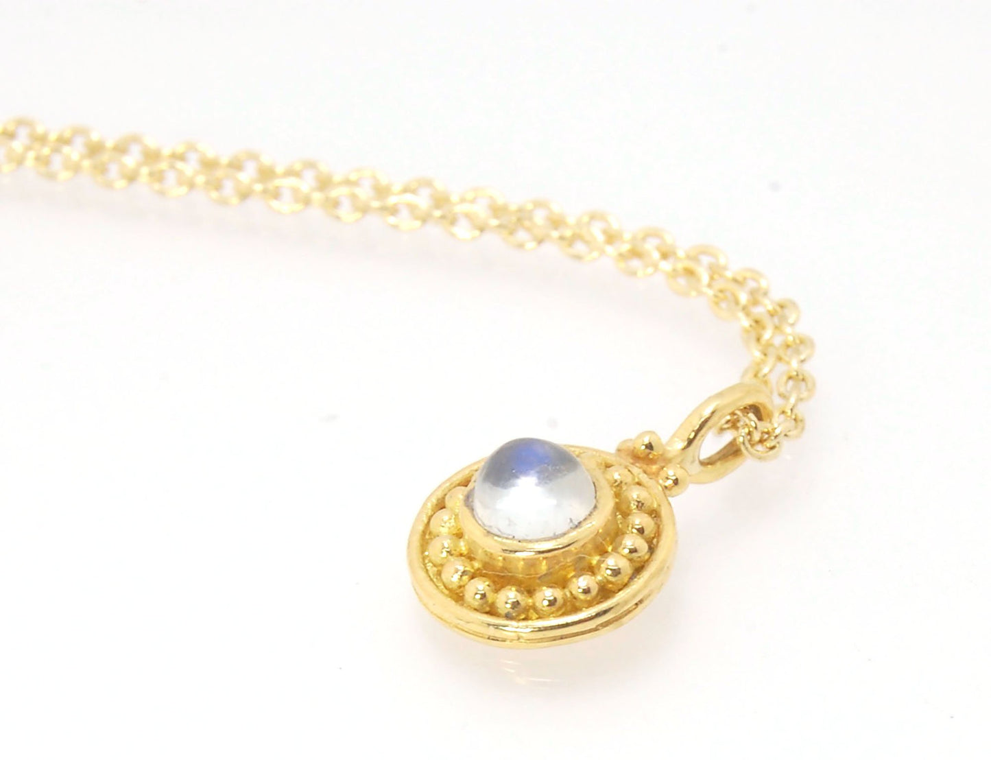 Tiny Round Rainbow Moonstone 18k gold Granulated Pendant This beautiful tiny round rainbow moonstone has so much luminance! A bezel-set small round rainbow moonstone is surrounded by larger 18k gold granules and can be ordered on the your chain of choice.