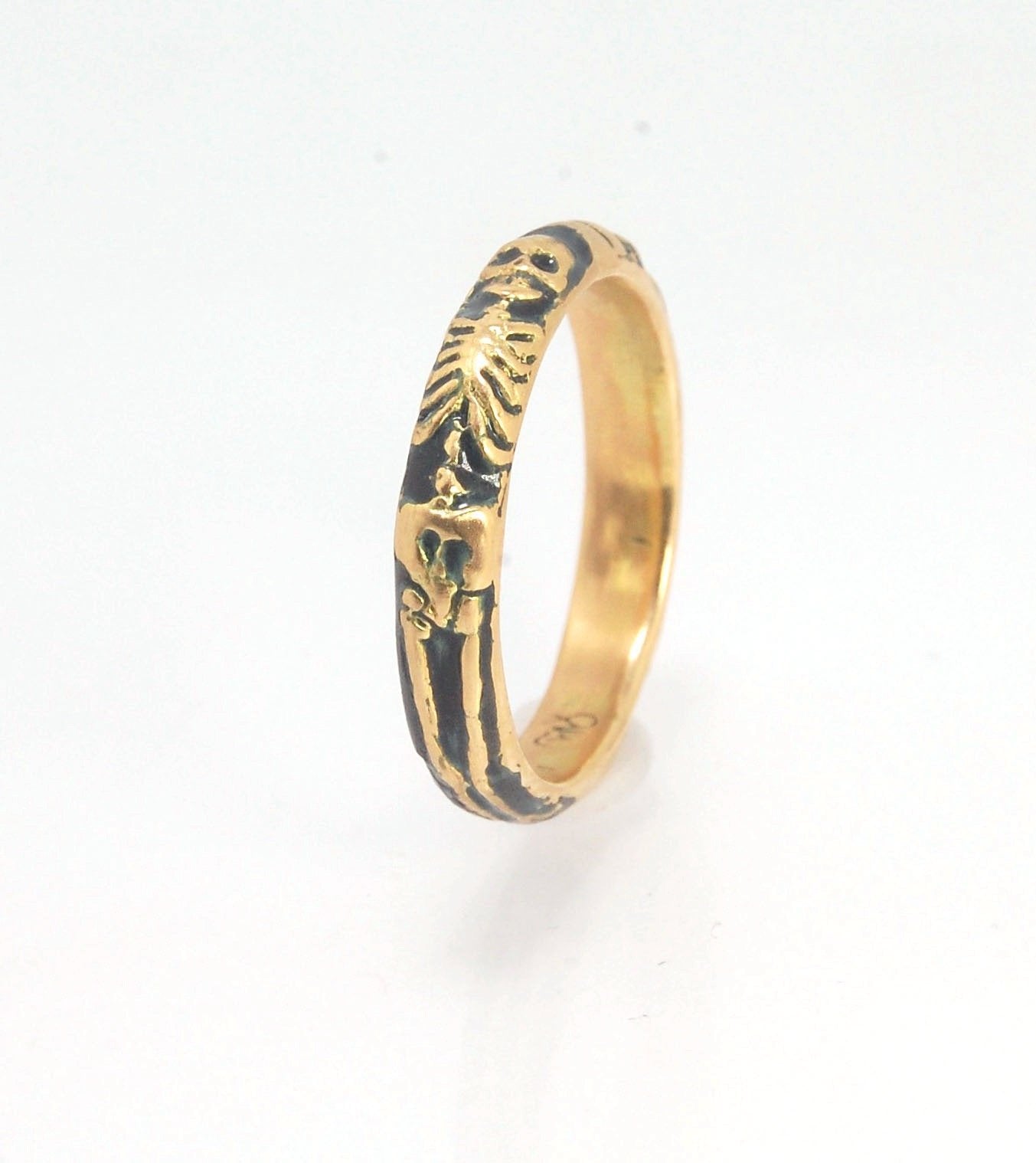 Memento Mori Skeleton Ring in 14k gold with enamel - Medium - 4mm This is the middle width of my Memento Mori skeleton rings at 4mm wide and cast in 14k rich yellow gold. The Skeleton is flanked by crossed bones on one side and an hourglass on the other.1