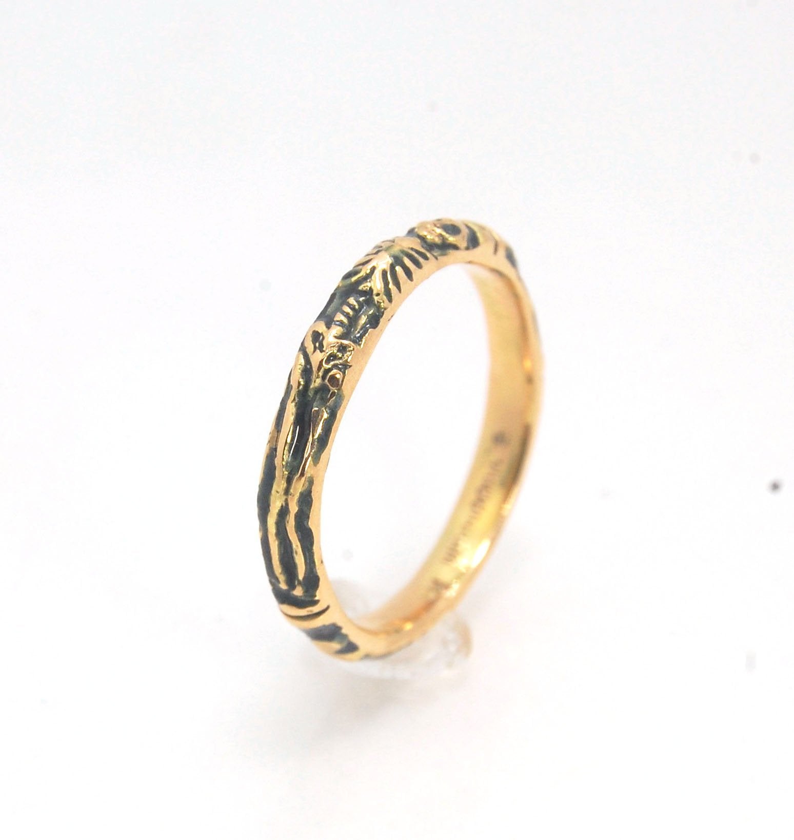 Memento Mori Skeleton Ring in 14k gold - 3mm This is the most narrow of my Memento Mori rings at 3mm wide and is cast in 14k rich yellow gold. The Skeleton is flanked by intertwined hearts on one side.14k rich yellow gold and EnamelMade to Order. Usually