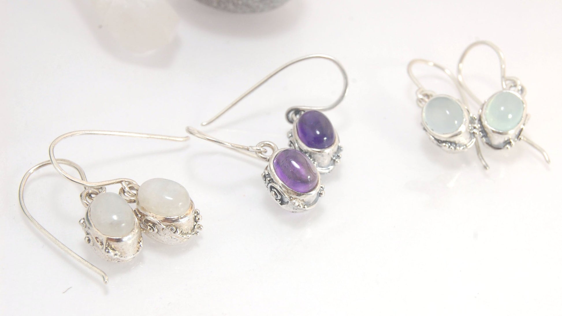 Oval Swirled Earrings with French Hooks in Sterling with your choice of Moonstone, Blue Chacedony, Amethyst, Rose Quartz, or Garnet These sweet swirled oval dangle earrings can be set with the stone of your choice: Moonstone, Blue Chacedony, Amethyst, Ros