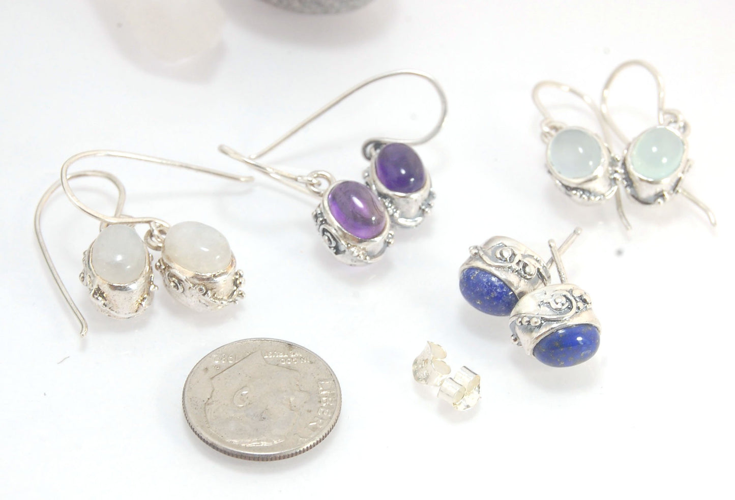 Oval Swirled Earrings with French Hooks in Sterling with your choice of Moonstone, Blue Chacedony, Amethyst, Rose Quartz, or Garnet These sweet swirled oval dangle earrings can be set with the stone of your choice: Moonstone, Blue Chacedony, Amethyst, Ros