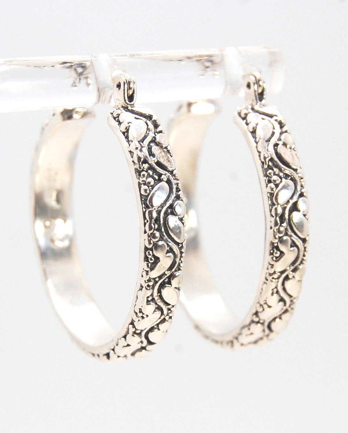 Oval Dots Hoop Earrings - Sterling Silver in 3 sizes These Hoops are made from an Oval and Dot pattern 4.7 mm wide band with ovals and heavy granules around a wavy center line. I made the original band in Fine silver using the process of Granulation. I th