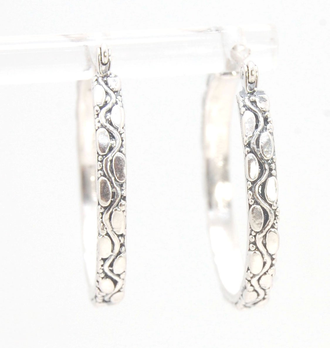 Ovals Pattern Hoops - Sterling in 3 sizes These Hoops are made from an Ovals pattern with heavy granules and ingot slices and have a hoop catch with a satisfying snap.These Ovals Hoops come in 3 sizes Large - 3mm wide and 1.25” in diameterMedium - 3mm wid