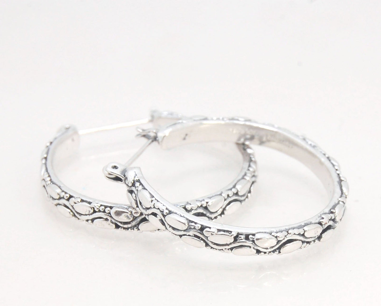 Ovals Pattern Hoops - Sterling in 3 sizes These Hoops are made from an Ovals pattern with heavy granules and ingot slices and have a hoop catch with a satisfying snap.These Ovals Hoops come in 3 sizes Large - 3mm wide and 1.25” in diameterMedium - 3mm wid