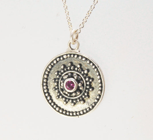 Pink Tourmaline Granulated Disk Pendant Faceted Pink Tourmaline bezel-set in Fine Silver Granulation.Granulation is a controlled fusing process that has been utilized for thousands of years. I melt 999.99% Fine Silver to create granules and wire. The gran