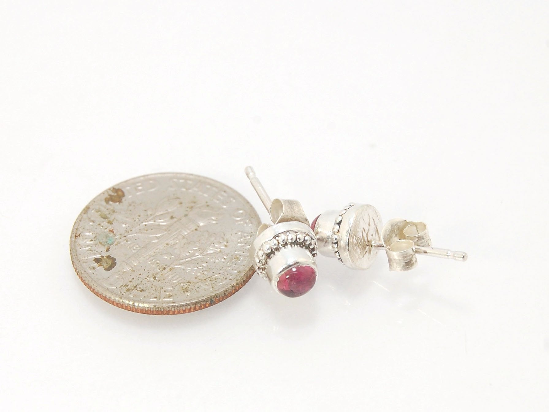 Etruscan Tiny Post Earrings in Sterling Silver These are tiny bezel settings I created using the ancient process of granulation. Then I made a mold of it, injected it with wax, and used that wax to create a Sterling Silver version of these granulated sett