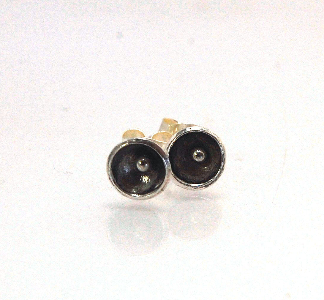 Poppy Post Earrings in Fine Silver These are tiny Fine Silver disks rounded into bowls with a tiny ball in the center to resemble a poppy. These are created using the ancient process of Granulation.6mmFine Silver Poppy, Sterling Post and EarnutMade to Ord