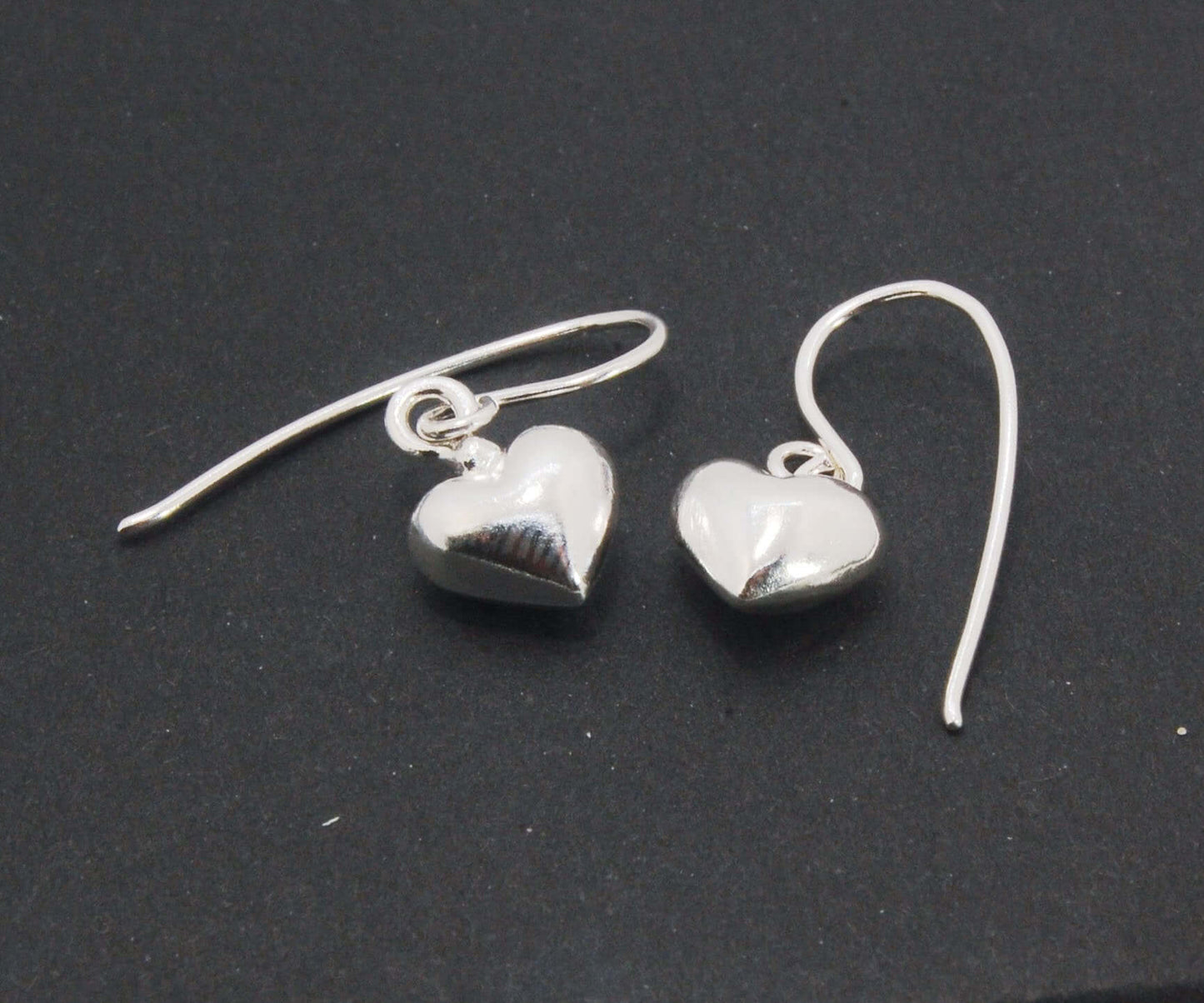 Puffy Heart Dangles - Large - Oxidized These terrific heart dangle earrings are cast from a wax carved original and are cast using the lost wax process. I then make a mold, then a wax copy, and through the process of lost wax casting I make these cast ear