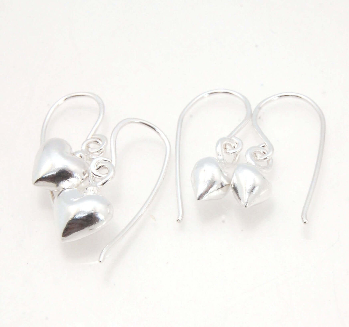 Puffy Heart Dangles - Small - Shiny These terrific heart dangle earrings are cast from a wax carved original and are cast using the lost wax process. I then make a mold, then a wax copy, and through the process of lost wax casting I make these cast earrin