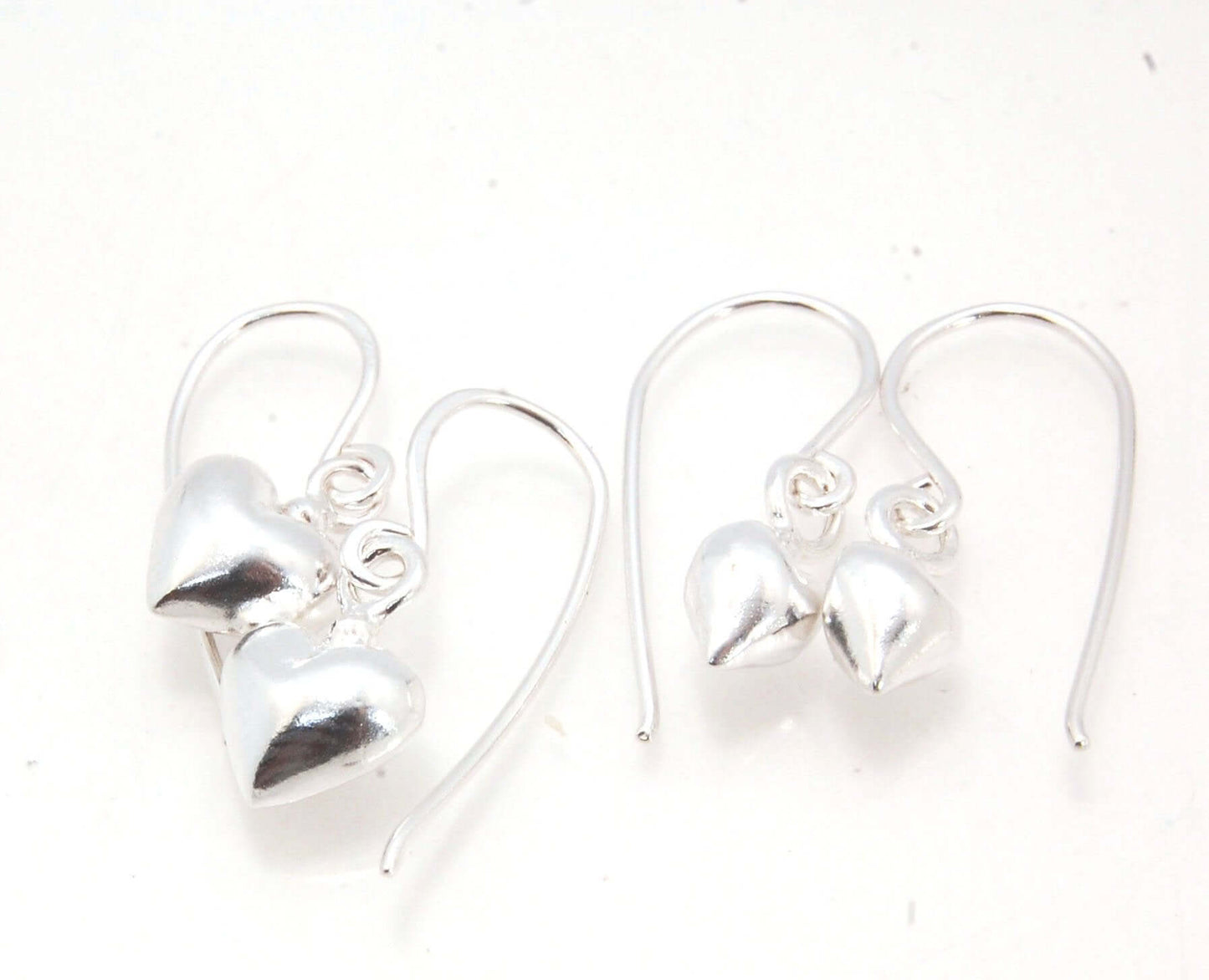 Puffy Heart Dangles - Large - Oxidized These terrific heart dangle earrings are cast from a wax carved original and are cast using the lost wax process. I then make a mold, then a wax copy, and through the process of lost wax casting I make these cast ear