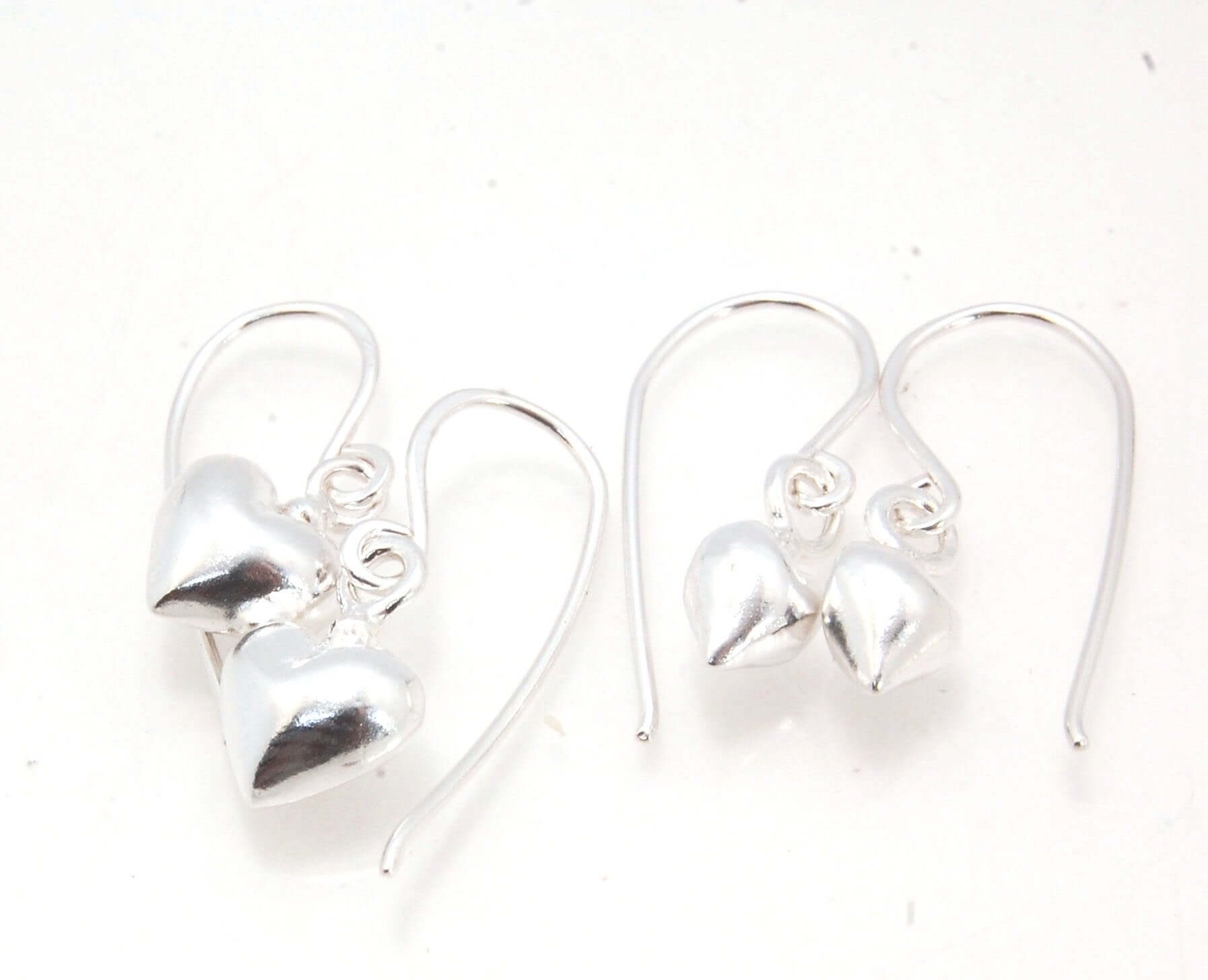 Puffy Heart Dangles - Small - Shiny These terrific heart dangle earrings are cast from a wax carved original and are cast using the lost wax process. I then make a mold, then a wax copy, and through the process of lost wax casting I make these cast earrin