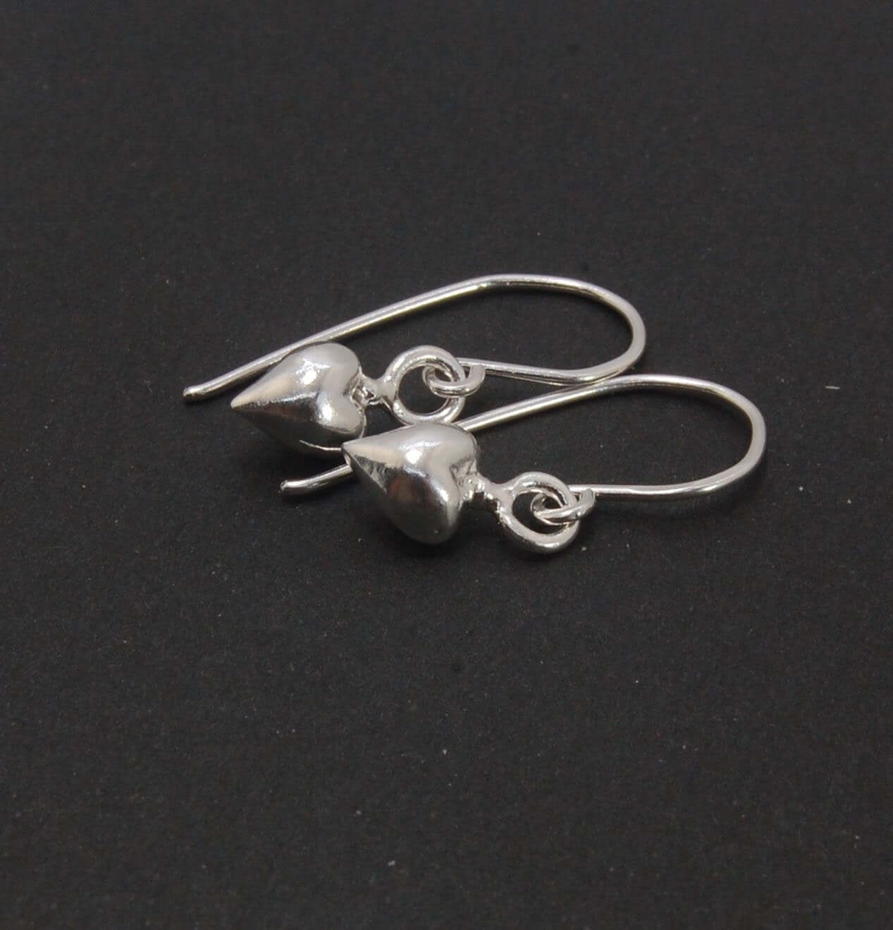 Puffy Heart Dangles - Small - Shiny These terrific heart dangle earrings are cast from a wax carved original and are cast using the lost wax process. I then make a mold, then a wax copy, and through the process of lost wax casting I make these cast earrin