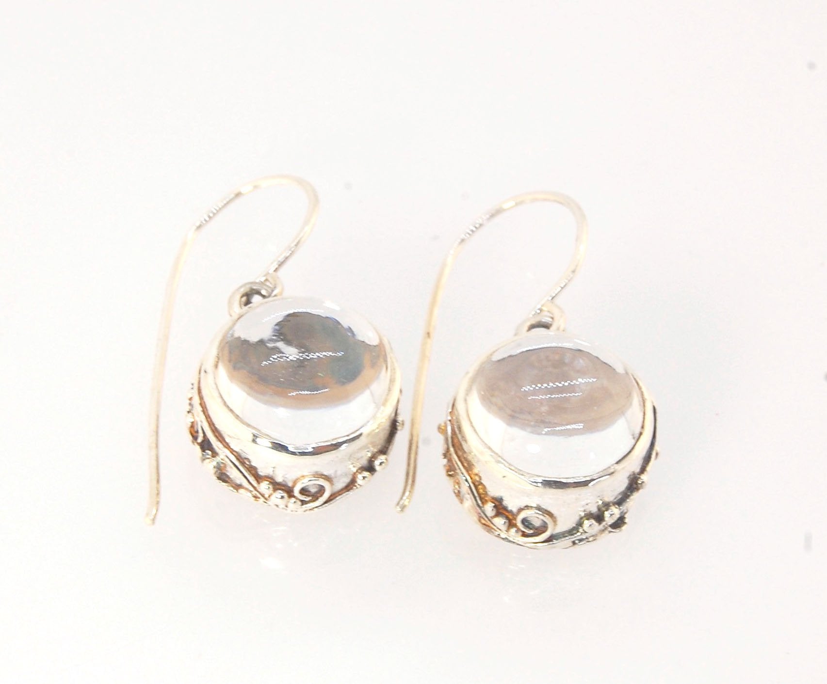 Clear Quartz Swirled Earrings with French Hook in Sterling - Large - 15mm These are cast in my studio using the ancient technique of lost wax casting with a wax model molded from an original granulated piece of fine silver.These clear quartz cabochon earr