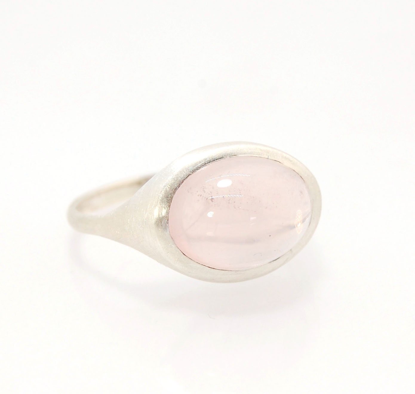 Rose Quartz Ring in Brushed Silver This is one of my first wax carved designs cast in sterling silver using a lost wax process. I start with a piece of wax and math and start carving until the ring is revealed! The back of the rIng is fully open so the ro