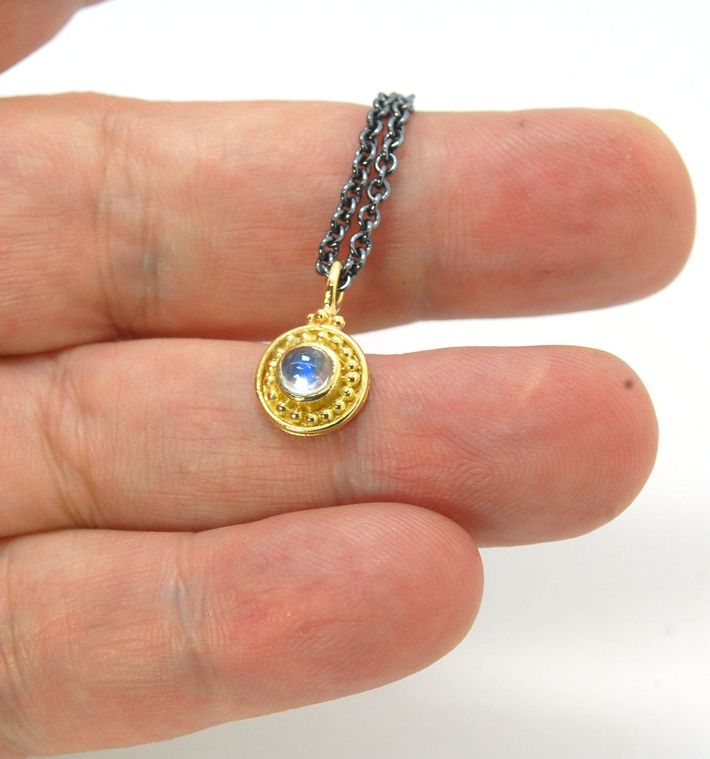 Tiny Round Rainbow Moonstone 18k gold Granulated Pendant This beautiful tiny round rainbow moonstone has so much luminance! A bezel-set small round rainbow moonstone is surrounded by larger 18k gold granules and can be ordered on the your chain of choice.