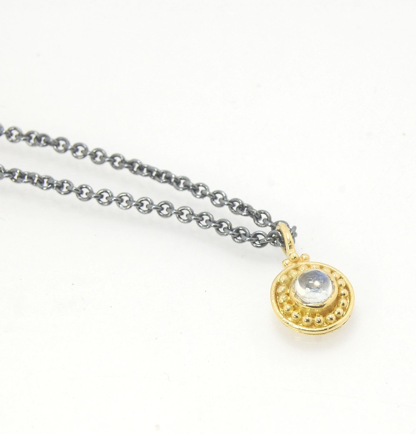 Tiny Round Rainbow Moonstone 18k gold Granulated Pendant This beautiful tiny round rainbow moonstone has so much luminance! A bezel-set small round rainbow moonstone is surrounded by larger 18k gold granules and can be ordered on the your chain of choice.