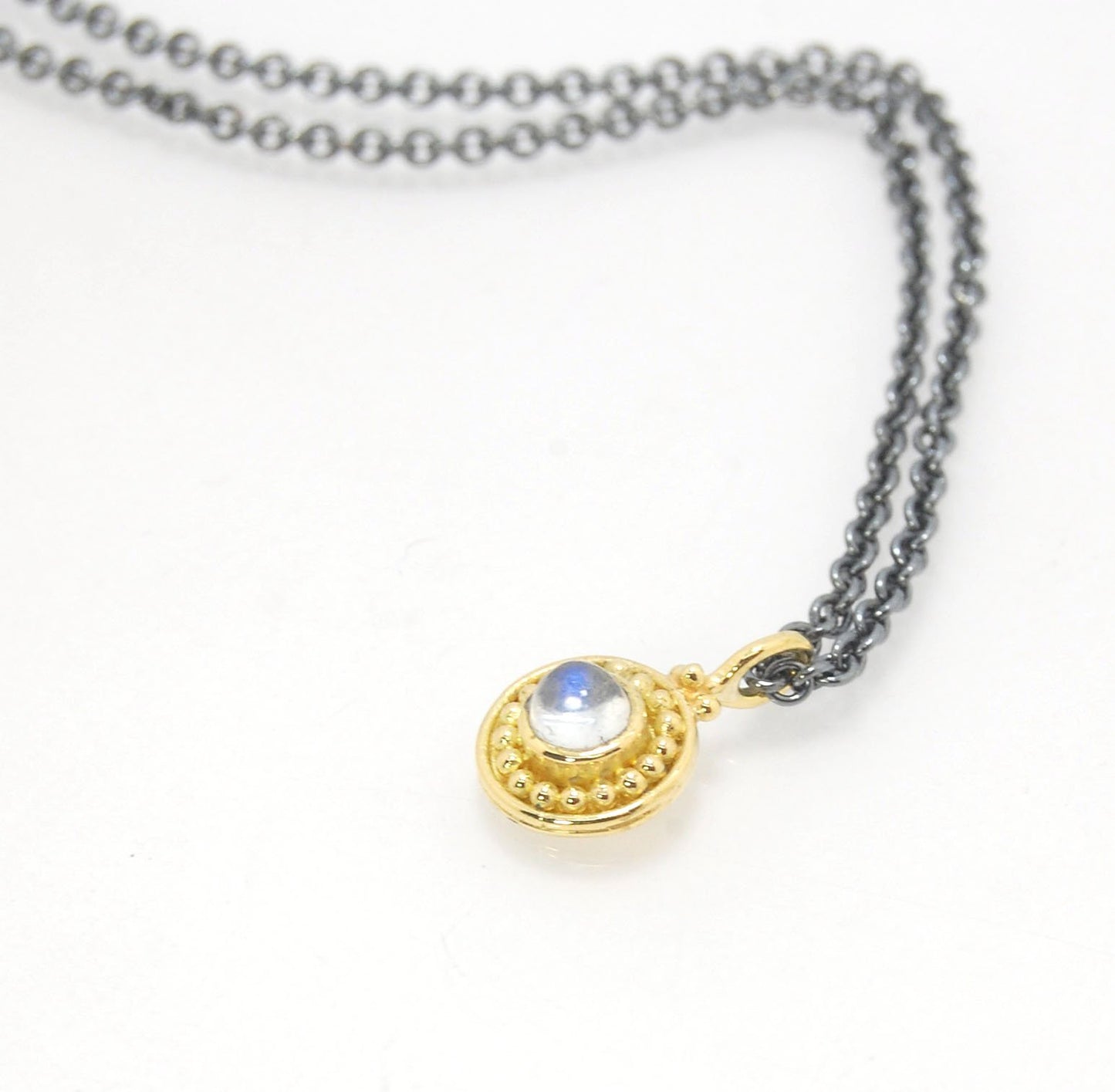 Tiny Round Rainbow Moonstone 18k gold Granulated Pendant This beautiful tiny round rainbow moonstone has so much luminance! A bezel-set small round rainbow moonstone is surrounded by larger 18k gold granules and can be ordered on the your chain of choice.