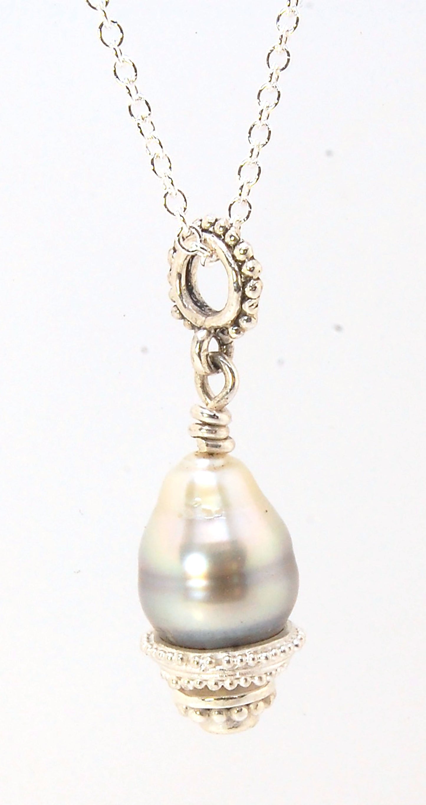 Grey Baroque Pearl with Fine Silver Granulation and Yellow Sapphire Grey Baroque Pearl with Fine Silver Granulation and Yellow SapphireThis grey baroque pearl is capped with one-of-a-kind fine silver granulation and a bezel set 2mm faceted yellow sapphire