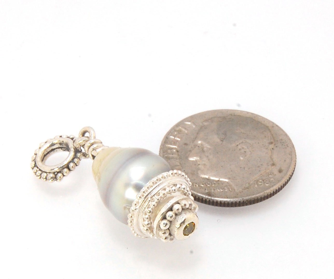 Grey Baroque Pearl with Fine Silver Granulation and Yellow Sapphire Grey Baroque Pearl with Fine Silver Granulation and Yellow SapphireThis grey baroque pearl is capped with one-of-a-kind fine silver granulation and a bezel set 2mm faceted yellow sapphire