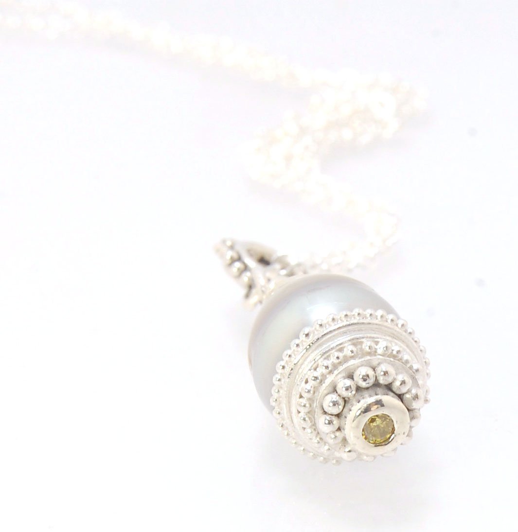 Grey Baroque Pearl with Fine Silver Granulation and Yellow Sapphire Grey Baroque Pearl with Fine Silver Granulation and Yellow SapphireThis grey baroque pearl is capped with one-of-a-kind fine silver granulation and a bezel set 2mm faceted yellow sapphire