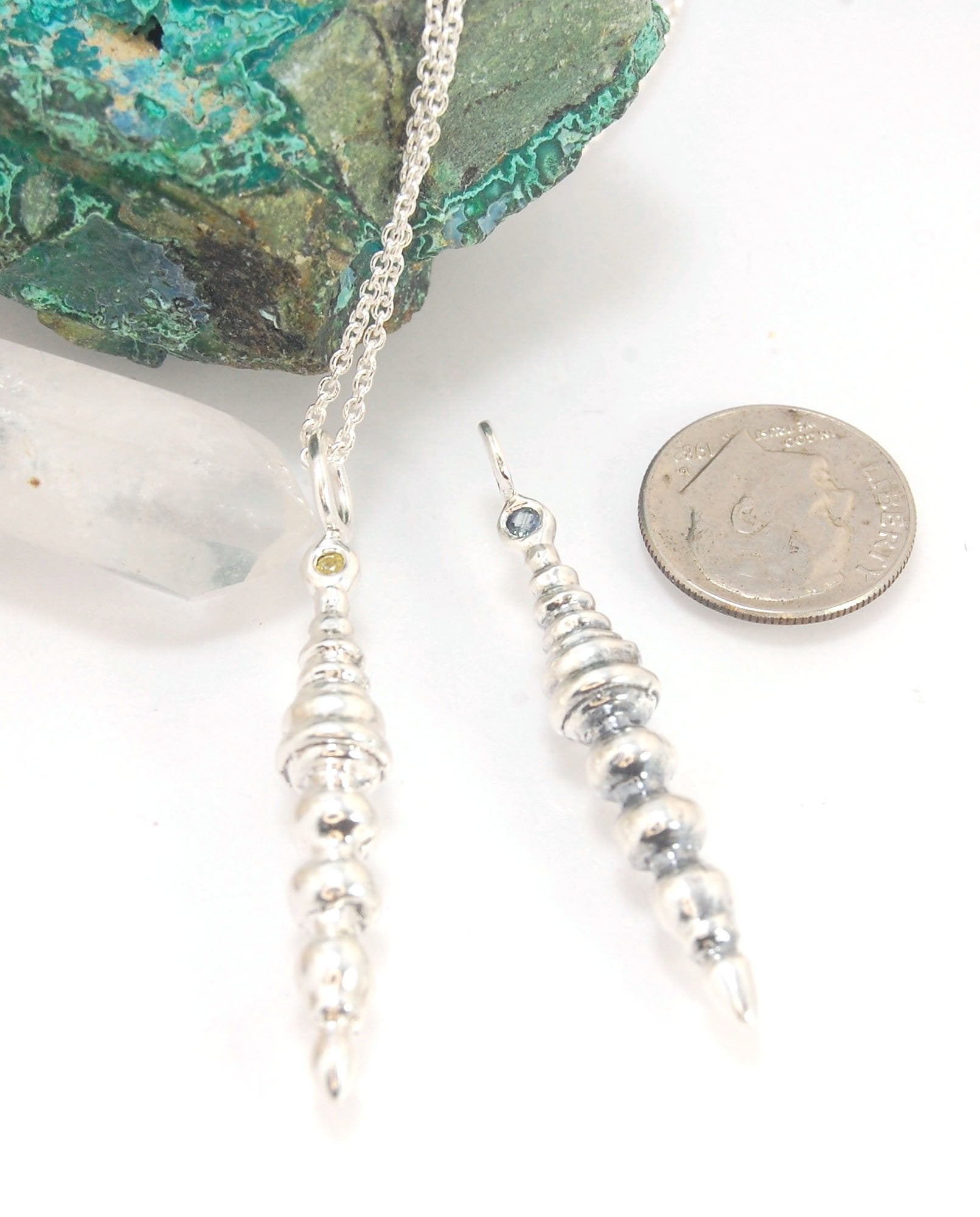 Seashell Pendulum Sterling This is part of a fun series of lathe-turned wax pieces. This seashell pendulum is elegant and feminine and mysterious.Carved in wax and cast using a lost-wax casting process, this piece is cast in sterling silver and can have a