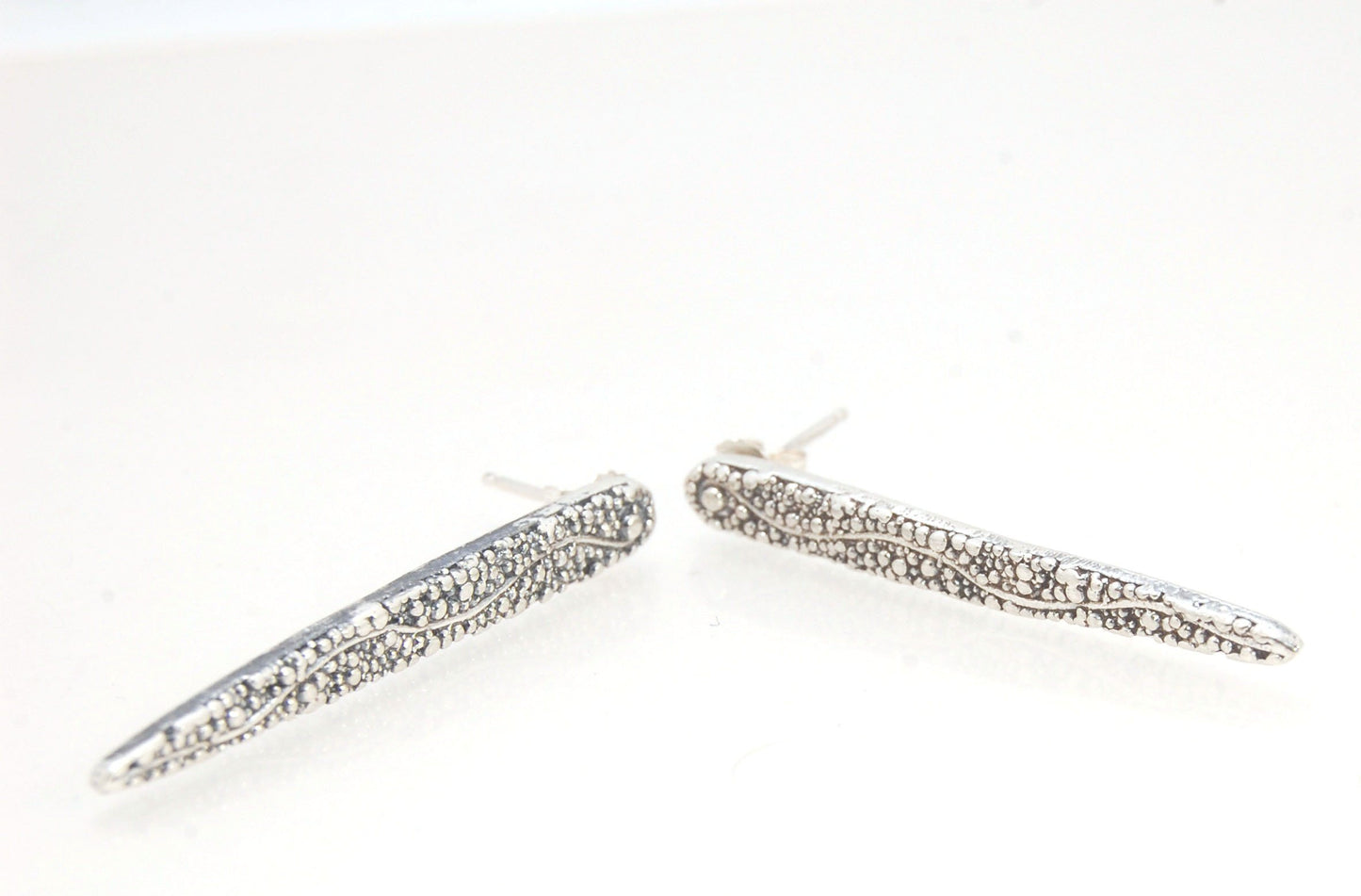 Seaweed Pattern Long Dagger Posts These seaweed dagger post earrings are long, elegant points of silver filled with a granulation pattern I call Seaweed, as it looks like it has so much movement in the varying-sized granules. These are cast versions of my