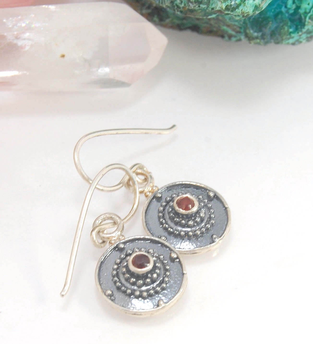 Dangle Shield Earrings in Sterling with Pink Garnet, Red Garnet, Blue Topaz, Peridot, or Amethyst These terrific shield earrings are cast from a granulated original. and is cast using the lost wax process. You can choose which stone to set in your sterlin