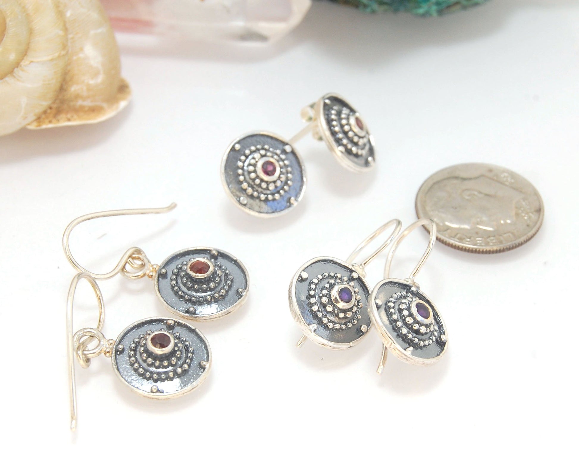 Dangle Shield Earrings in Sterling with Pink Garnet, Red Garnet, Blue Topaz, Peridot, or Amethyst These terrific shield earrings are cast from a granulated original. and is cast using the lost wax process. You can choose which stone to set in your sterlin