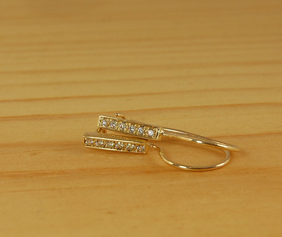 Short Tiny Diamond Earrings with french Hook and clasp - 14k yellow gold These great little sparklers are subtle enough for every day as long as you don’t mind everyone noticing! They have 6 x 1.3mm diamonds in a single pave row. Earrings have french hook