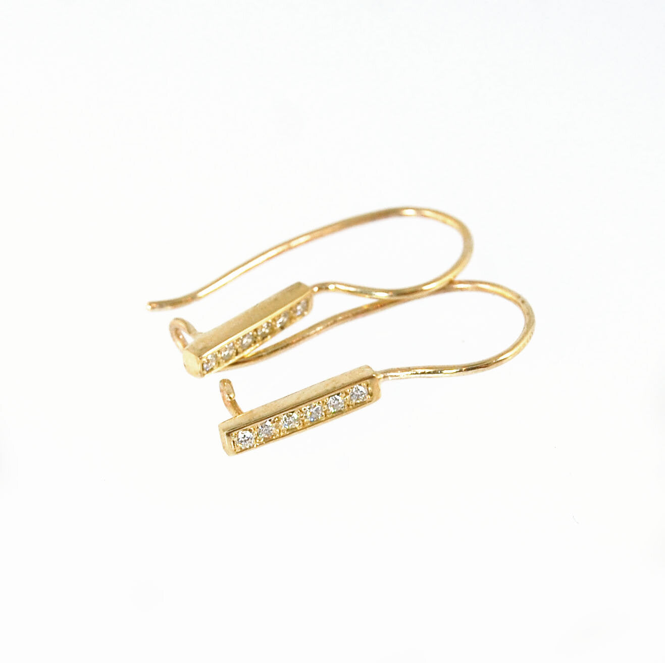 Short Tiny Diamond Earrings with french Hook and clasp - 14k yellow gold These great little sparklers are subtle enough for every day as long as you don’t mind everyone noticing! They have 6 x 1.3mm diamonds in a single pave row. Earrings have french hook