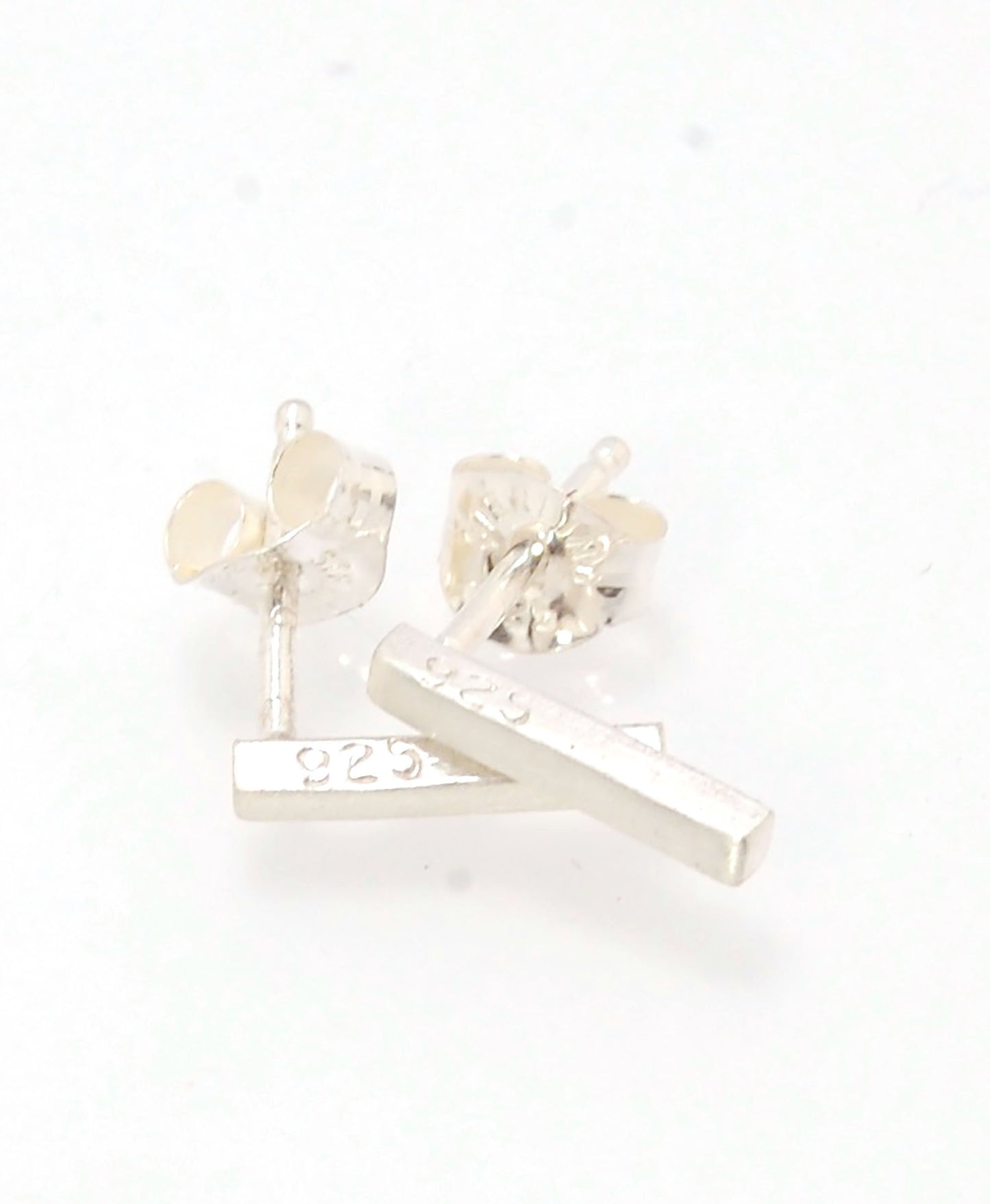 Silver Bar Post Earrings These are milled from sterling silver ingots here in my studio in my rolling mill. I then square the ingots with a hammer and add posts with my torch. These silver post earrings have a brushed finish.2mm x 9mmSterling SIlver Made