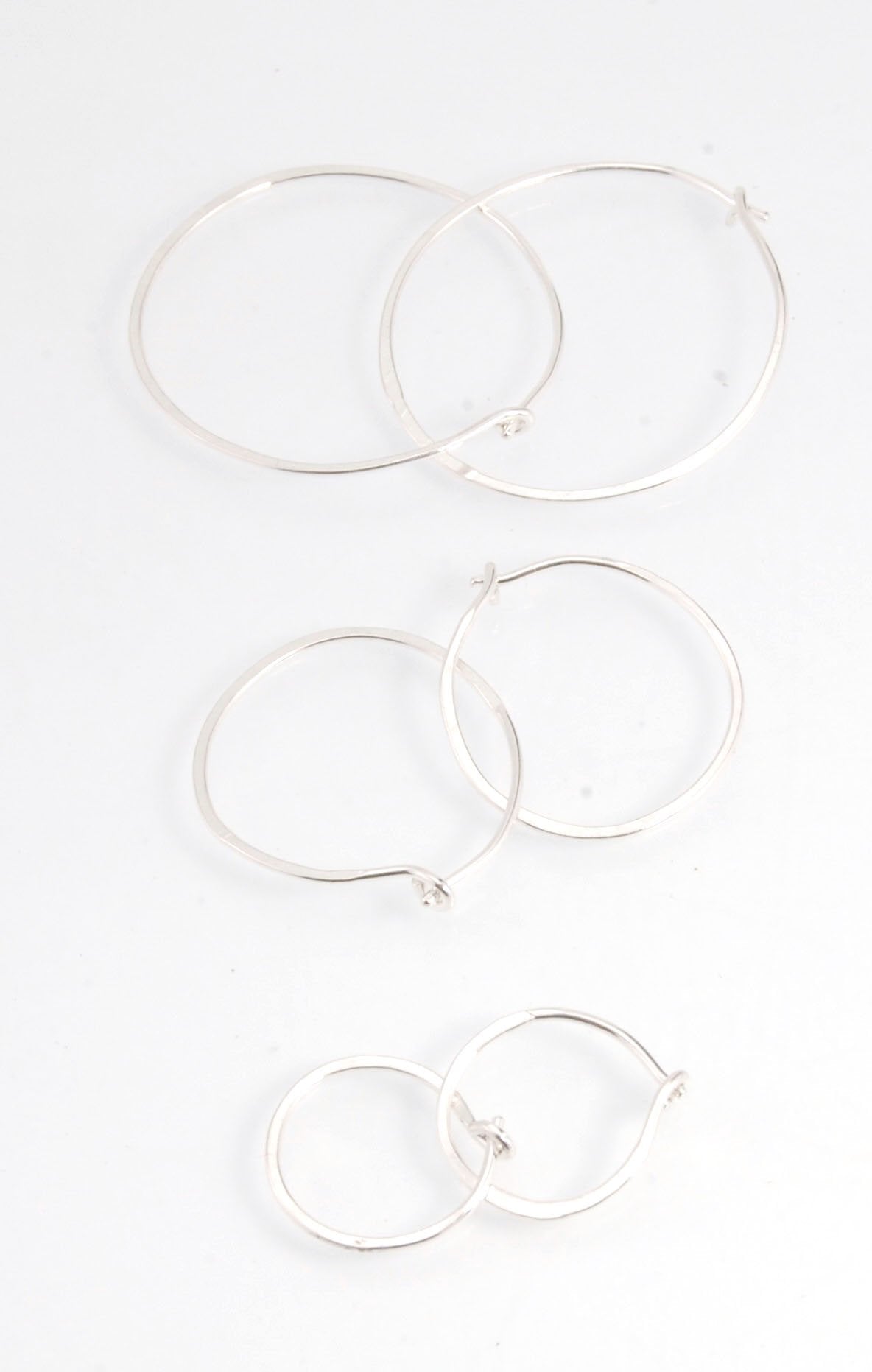 Hammered Hoops - Sterling - Small, Medium and Large Looking for an affordable handmade gift? Or some super lightweight Sterling Silver Hoops you can live in? These classic wire hammered hoops you can sleep and live in are forged from 20 gage Sterling wire