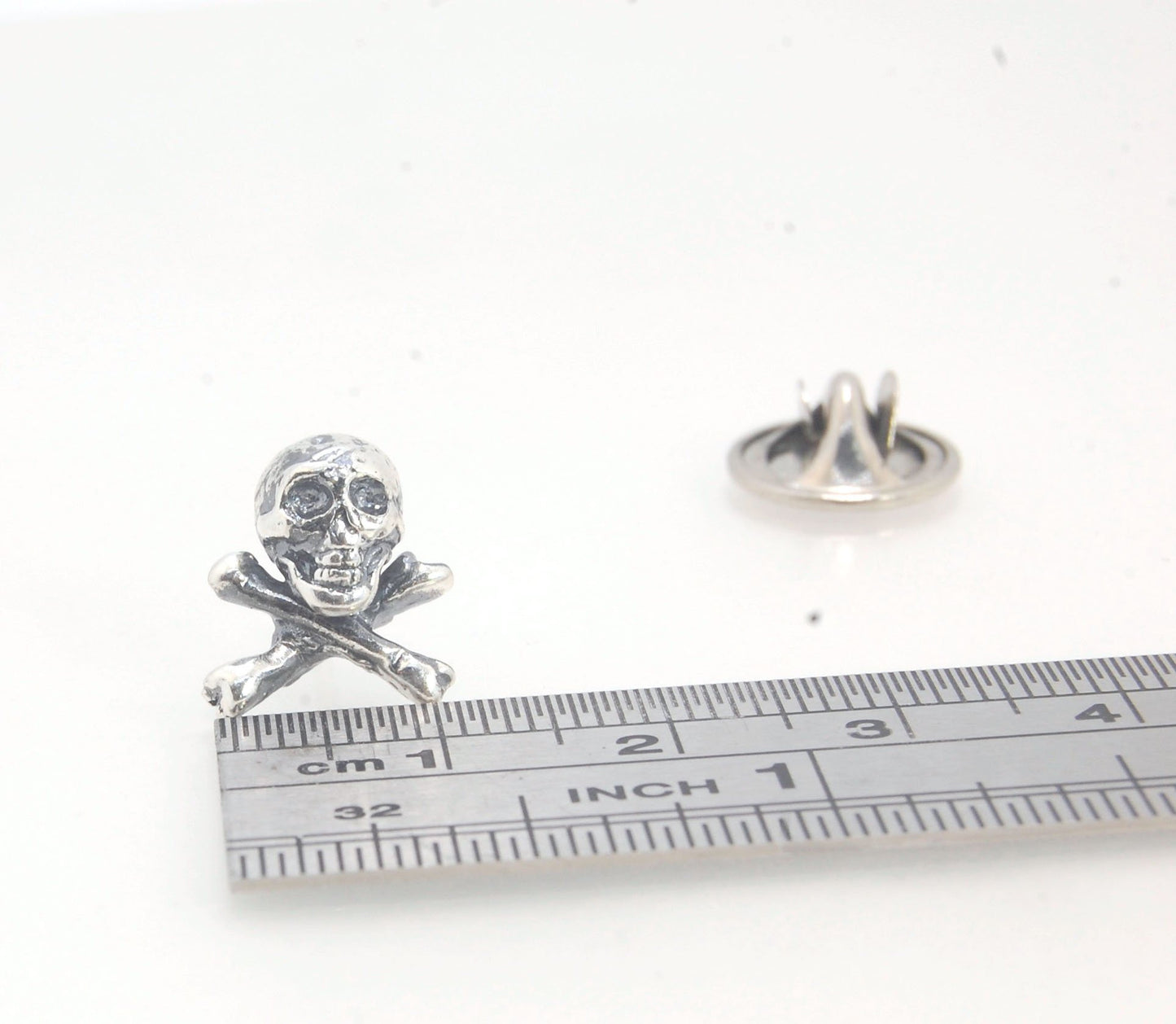 Skull & Bones Tie Tack Lapel Pin This solid sterling silver Skull & Bones tie tack label pin is wax carved by hand and cast using the ancient process of Lost Wax in sterling silver. I then made a mold, which I can inject with wax and make wax copies of th