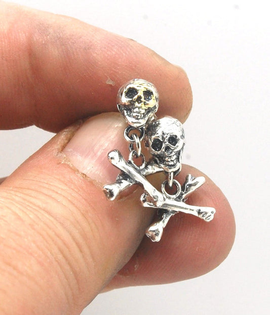 Skull & Bones Dangle Post Earrings These solid sterling silver Skull & Bones dangle earrings are wax carved by hand and cast using the ancient process of Lost Wax to cast them in sterling silver. I then made a mold, which I can inject with wax and make wa