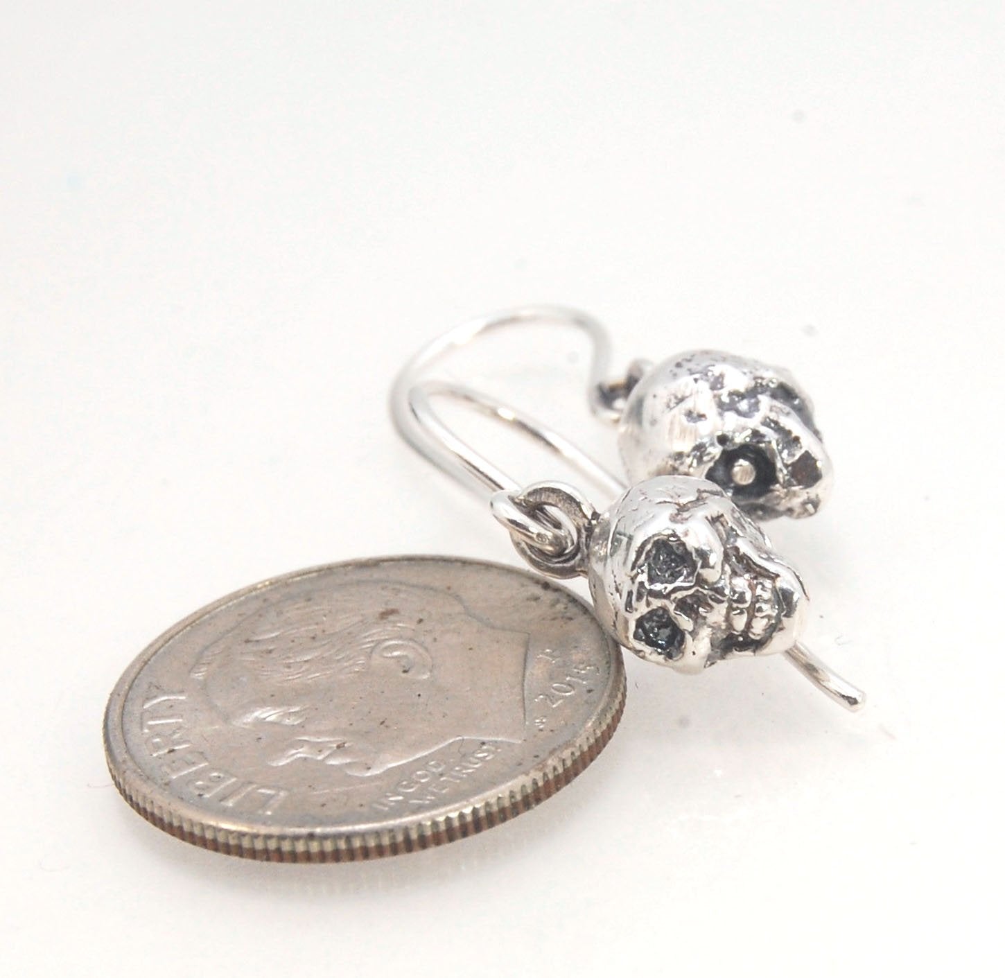 Skull Dangle Earrings This solid sterling silver Skull Pendant is wax carved by hand and cast using the ancient process of Lost Wax casting. I then made a mold, which I can inject with wax and make wax copies of the Jolly Roger Pendant and cast a lot of t