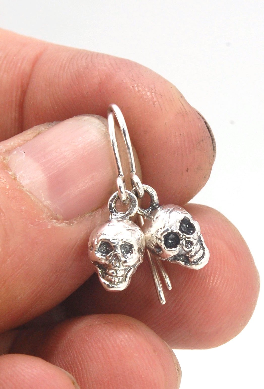 Skull Dangle Earrings This solid sterling silver Skull Pendant is wax carved by hand and cast using the ancient process of Lost Wax casting. I then made a mold, which I can inject with wax and make wax copies of the Jolly Roger Pendant and cast a lot of t